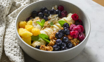 Fresh or frozen blueberry smoothie bowl with toppings